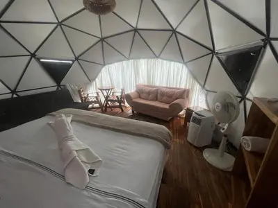 a room with a bed and a couch in a room at La Cabaña Glamping Geronimo in Playa Blanca
