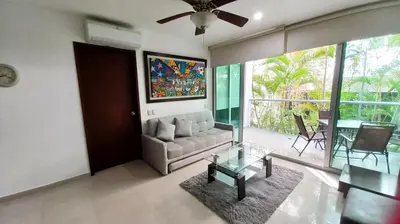 a living room with a couch and a glass table at Apartasuite Morros Vitri in Cartagena de Indias