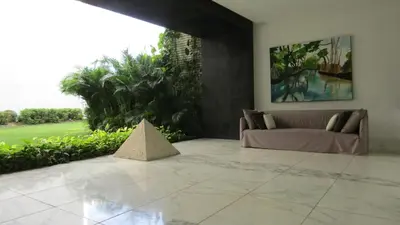a living room with a couch and a pyramid sculpture at Apartasuite Morros Vitri in Cartagena de Indias