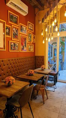a restaurant with wooden tables and chairs in a room at Maloka Boutique Centro Histórico in Cartagena de Indias