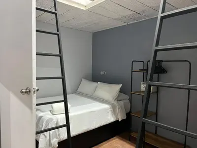 a bedroom with two bunk beds and a ladder at Maloka Boutique Centro Histórico in Cartagena de Indias