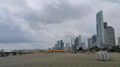 a group of people standing on a beach with a kite at Apartamento 1904 El Laguito in Cartagena de Indias