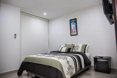 a bedroom with a bed in a white wall at Cartagena Beach Front in Cartagena de Indias