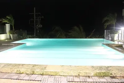 a large pool with blue water at night at Cartagena Beach Front in Cartagena de Indias