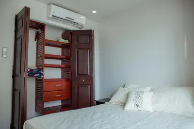 a bedroom with a bed and a book shelf at Cartagena Beach Front in Cartagena de Indias
