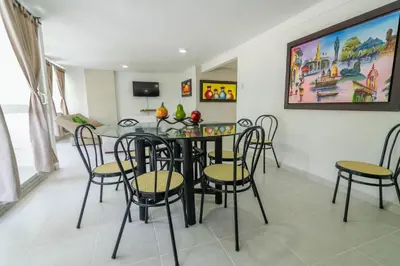 a dining room with a table and chairs at Apartamento Unik Cartagena Edificio Faro Tequendama in Cartagena de Indias