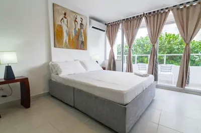 a bedroom with a bed and a large window at Apartamento Unik Cartagena Edificio Faro Tequendama in Cartagena de Indias