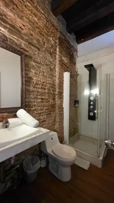 a bathroom with a toilet and a sink and a shower at Hotel Casa la Tablada in Cartagena de Indias