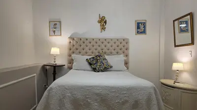 a bedroom with a bed with two lamps and two pillows at Hotel Casa la Tablada in Cartagena de Indias