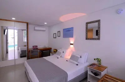 a bedroom with a bed with two laptops on it at Hotel Casa Cytia in Cartagena de Indias