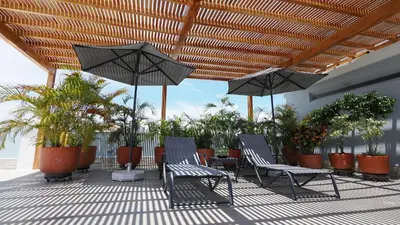 two chairs and umbrellas on a patio with plants at Hotel Casa Cytia in Cartagena de Indias