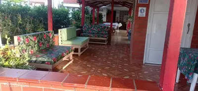 a group of chairs sitting on a porch at Ortimar in Tolú