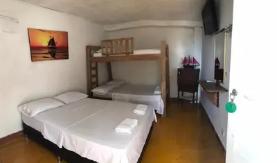 a bedroom with two bunk beds and a desk at Ortimar in Tolú