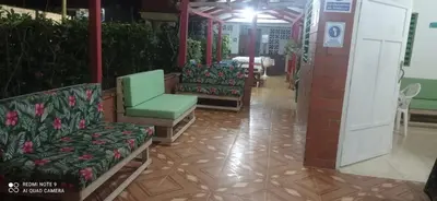 a hallway with chairs and tables in a building at Ortimar in Tolú