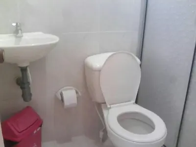 a bathroom with a white toilet and a sink at Ortimar in Tolú