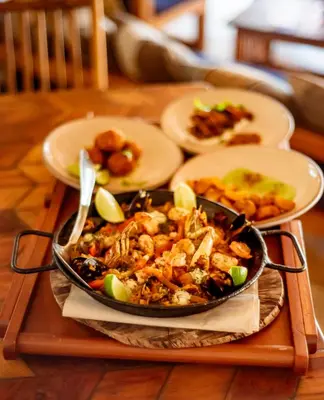 a tray with a pan of food on a table at Blue Apple Beach in Tierra Bomba