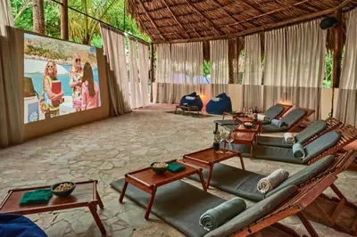 a living room with a couch and a movie screen at Blue Apple Beach in Tierra Bomba