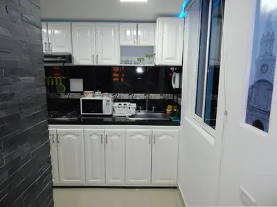 a white kitchen with a sink and a microwave at Apartment Lux Bocagrande in Cartagena de Indias
