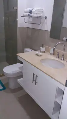 a bathroom with a sink and a toilet and a mirror at Apartamento Morros Epic Cartagena in Cartagena de Indias