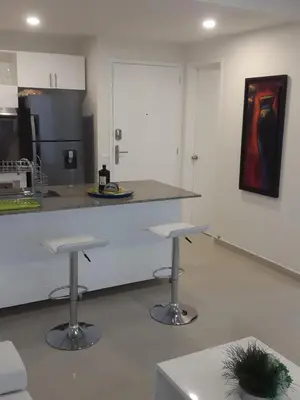 a kitchen with two bar stools and a counter top at Apartamento Morros Epic Cartagena in Cartagena de Indias