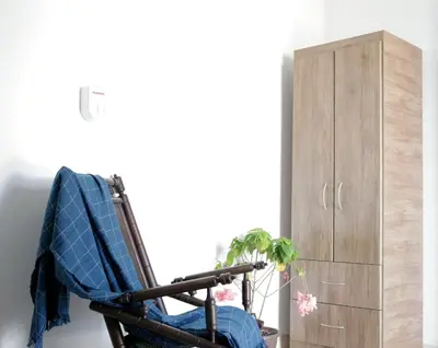 a rocking chair next to a cabinet and a plant at Casa Edith in Cartagena de Indias