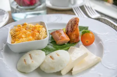 a white plate of food with a bowl of food at Hotel Casa Noi in Cartagena de Indias