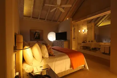 a bedroom with a large bed and a bathroom at Hotel Casa Noi in Cartagena de Indias