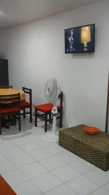 a room with a fan and chairs and a tv at Edificio Nuevo Conquistador in Cartagena de Indias