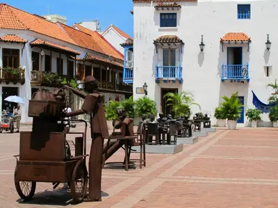 a statue of a woman pulling a cart on a street at Edificio Nuevo Conquistador in Cartagena de Indias