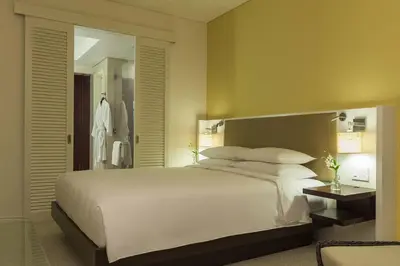 a bedroom with a large white bed and a mirror at Hyatt Regency Cartagena in Cartagena de Indias
