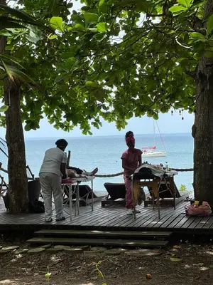 two people standing on a deck near the ocean at Isla Fuerte Eco House in Isla Fuerte