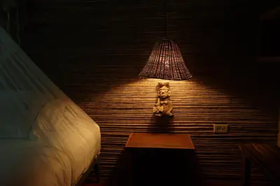 a teddy bear sitting on a table under a lamp at Isla Fuerte Eco House in Isla Fuerte
