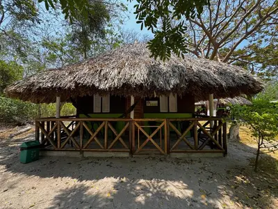 a small hut with a thatched roof at Eco Hotel Bosque Encantado in Isla Grande