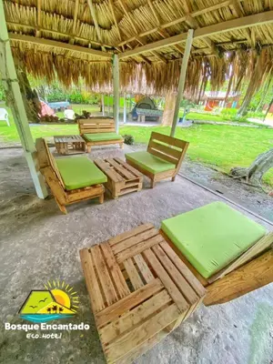 a group of chairs and tables under a pavilion at Eco Hotel Bosque Encantado in Isla Grande