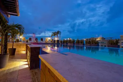 a swimming pool in a resort at night at Crowne Plaza Barranquilla by IHG in Barranquilla