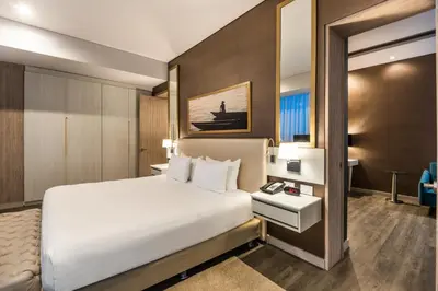 a hotel room with a bed and a desk at Crowne Plaza Barranquilla by IHG in Barranquilla