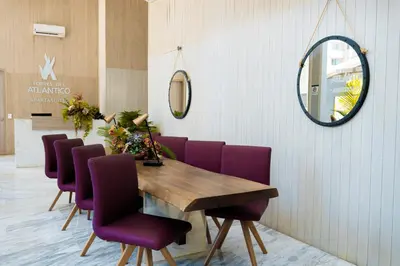 a dining room with a wooden table and purple chairs at Crowne Plaza Barranquilla by IHG in Barranquilla