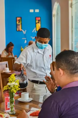 a man wearing a face mask at a table at Hotel Isla Capri in Cartagena de Indias