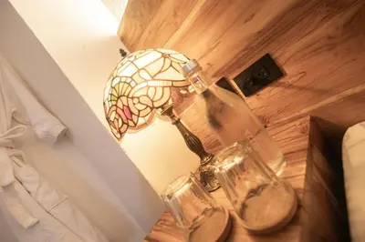 a lamp and two glass bottles on a table at Casa Be Getsemaní in Cartagena de Indias