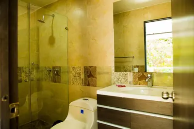 a bathroom with a toilet and a sink and a shower at Hollywood Beach Suite in Cartagena de Indias