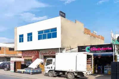 a white truck parked in front of a building at Hotel Masinda in Cartagena de Indias