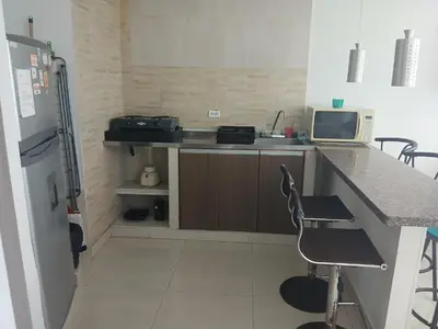 a small kitchen with a counter and a refrigerator at Cartagena Linda 204 in Cartagena de Indias