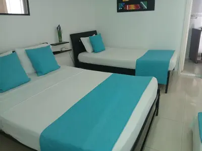 two beds in a room with blue and white at Cartagena Linda 204 in Cartagena de Indias