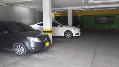 two cars are parked in a parking garage at Hotel Sandiego inc in Barranquilla