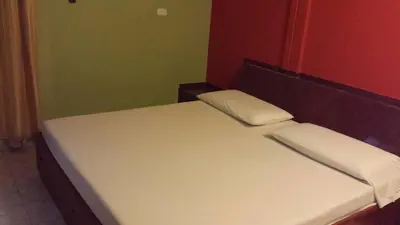 a bed with two pillows on it in a room at Hotel Sandiego inc in Barranquilla
