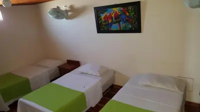 a room with two beds and a painting on the wall at Hotel Sandiego inc in Barranquilla