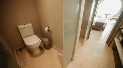 a bathroom with a toilet and a glass shower at Loa Tolú by Bernalo Hotels in Tolú