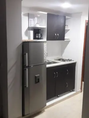 a kitchen with a stainless steel refrigerator and a stove at Apartamento Playero in Cartagena de Indias
