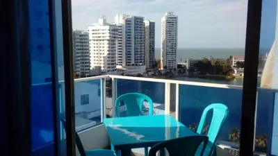 a table and chairs on a balcony with a view of the city at Apartamento Playero in Cartagena de Indias