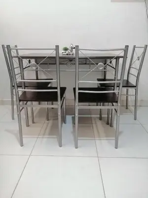 a dining room table with two chairs and a table with a plant at Apartamento Marbella #2-14 in Cartagena de Indias